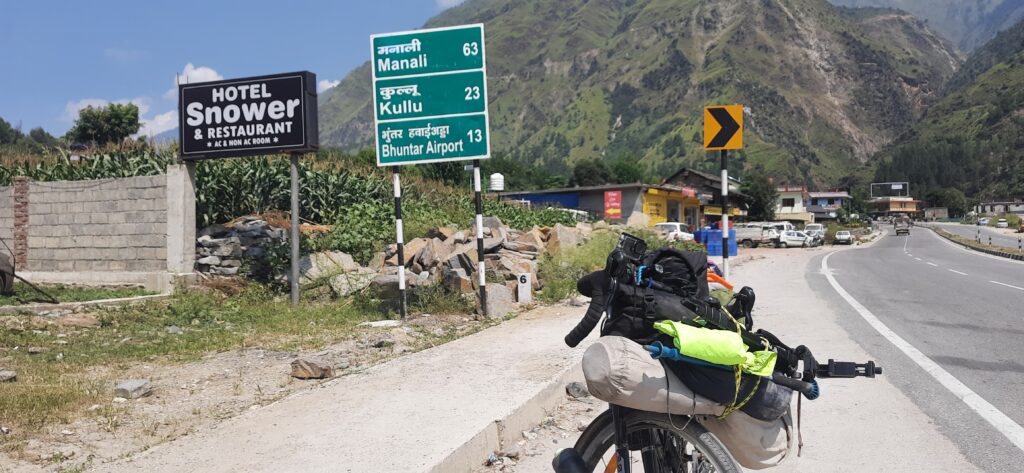 Sign board on NH3 showing Kullu is 23km away.