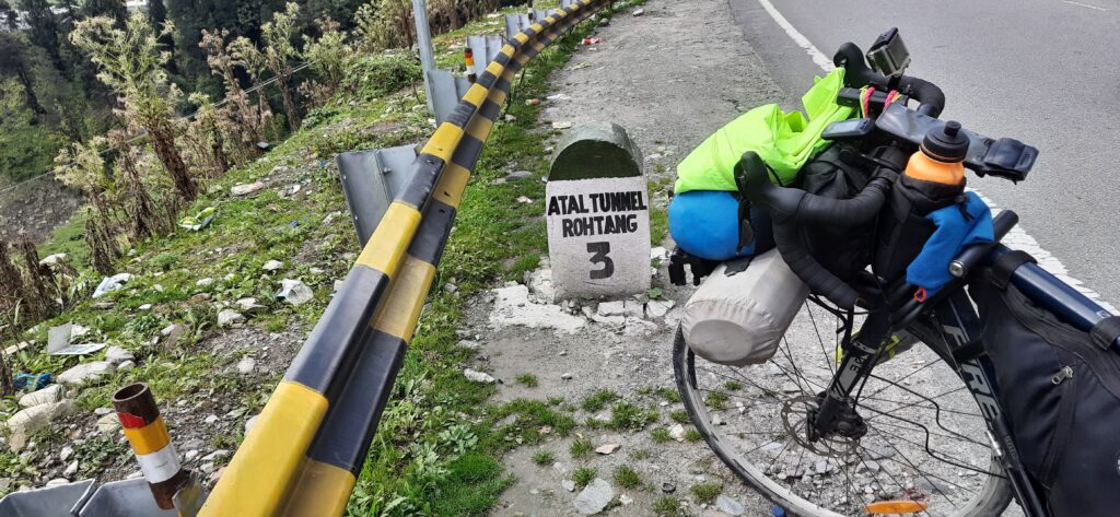 signpost showing distance of Atal tunnel